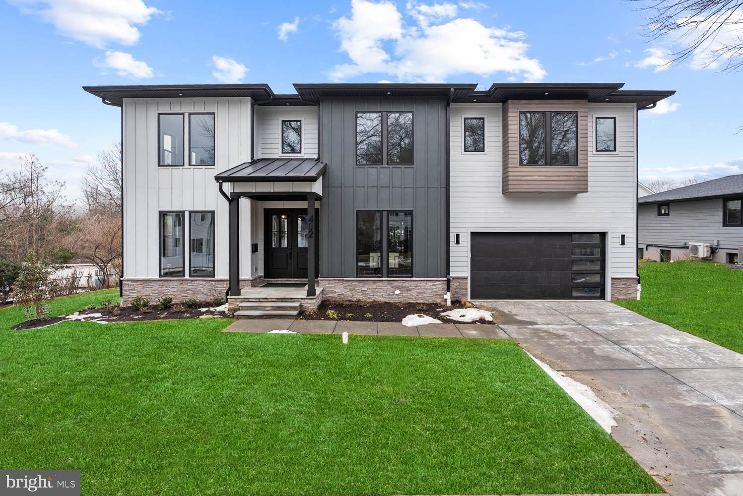 a front view of a house with a garden and yard