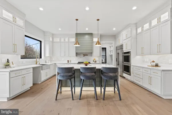a kitchen with granite countertop white cabinets and sink