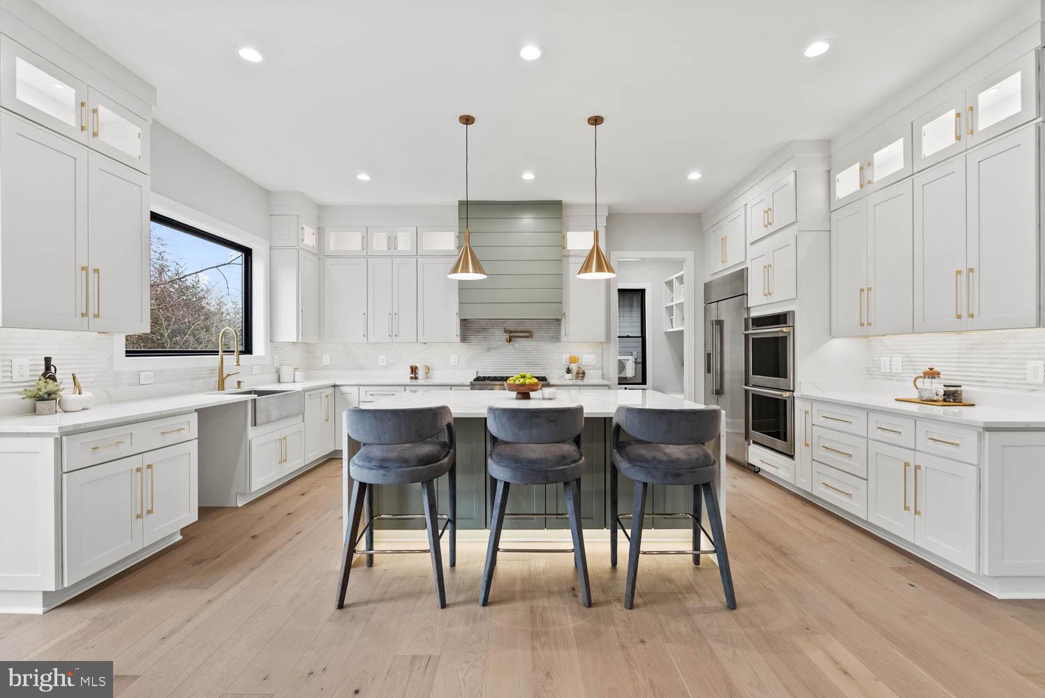 402 Marshall Road Southwest Vienna, VA 22180 - Photo 14 of 78 a kitchen with stainless steel appliances kitchen island granite countertop a table chairs sink and cabinets