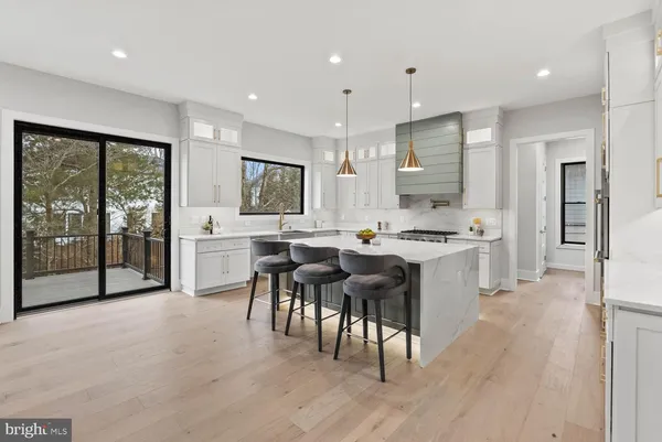 a kitchen with a sink cabinets and a stove top oven