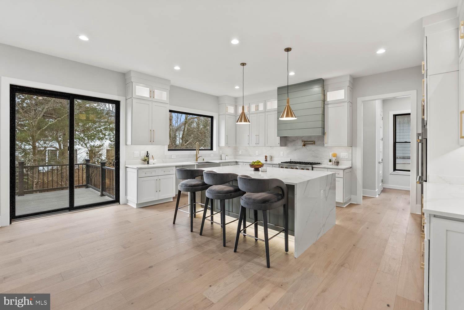 402 Marshall Road Southwest Vienna, VA 22180 - Photo 15 of 78 a open kitchen with granite countertop a stove top oven a sink a dining table and chairs