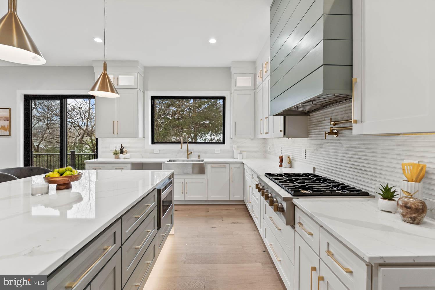 402 Marshall Road Southwest Vienna, VA 22180 - Photo 18 of 78 a kitchen with stainless steel appliances granite countertop a sink stove cabinets wooden floor and a window