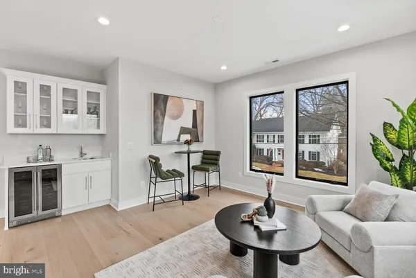 a bedroom with a bed a mirror and a large window