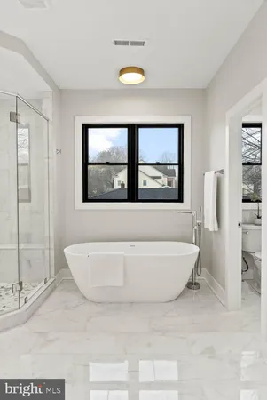 a bathroom with a toilet a sink and bathtub