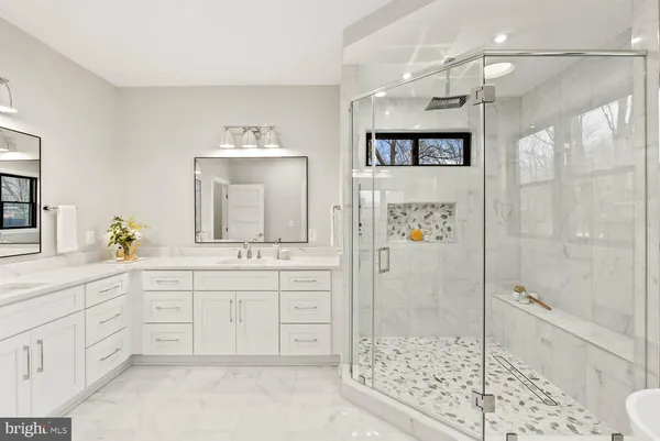a kitchen with white cabinets and sink