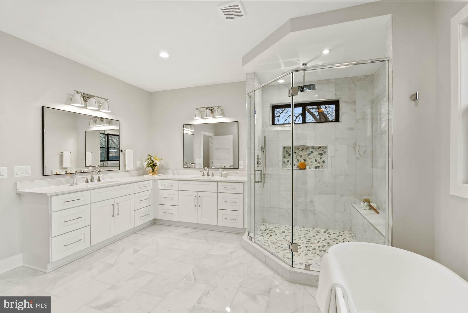 402 Marshall Road Southwest Vienna, VA 22180 - Photo 42 of 78 a spacious bathroom with a granite countertop tub sink a mirror a shower and vanity