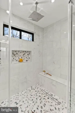 a bathroom with a granite countertop toilet sink and mirror