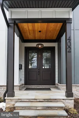 a view of a dining room with furniture and a chandelier