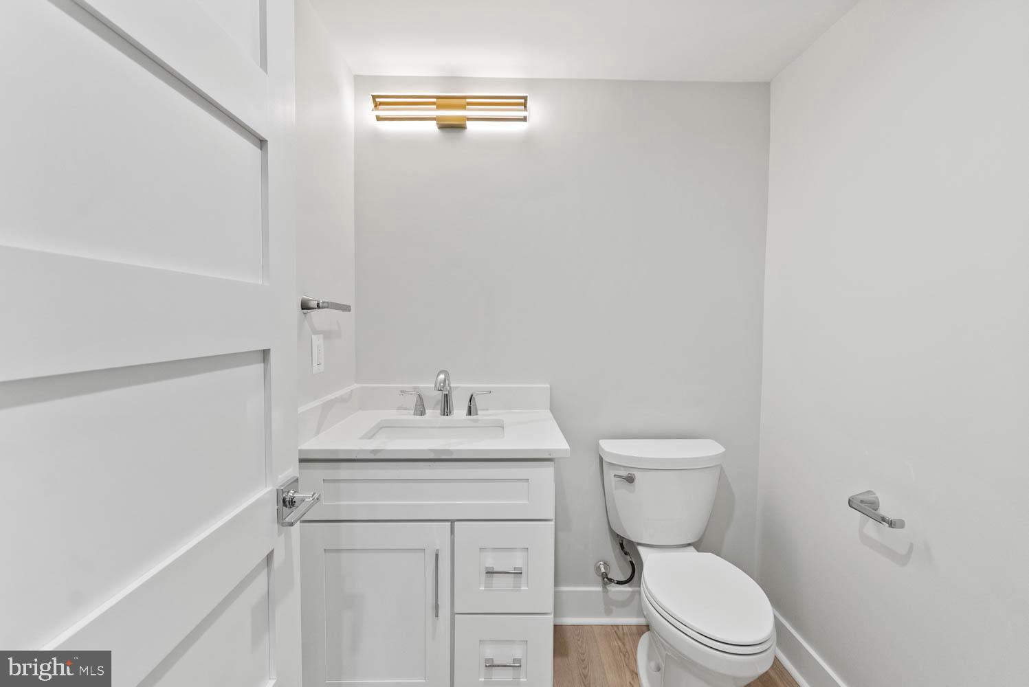 402 Marshall Road Southwest Vienna, VA 22180 - Photo 64 of 78 a bathroom with a granite countertop toilet sink and mirror