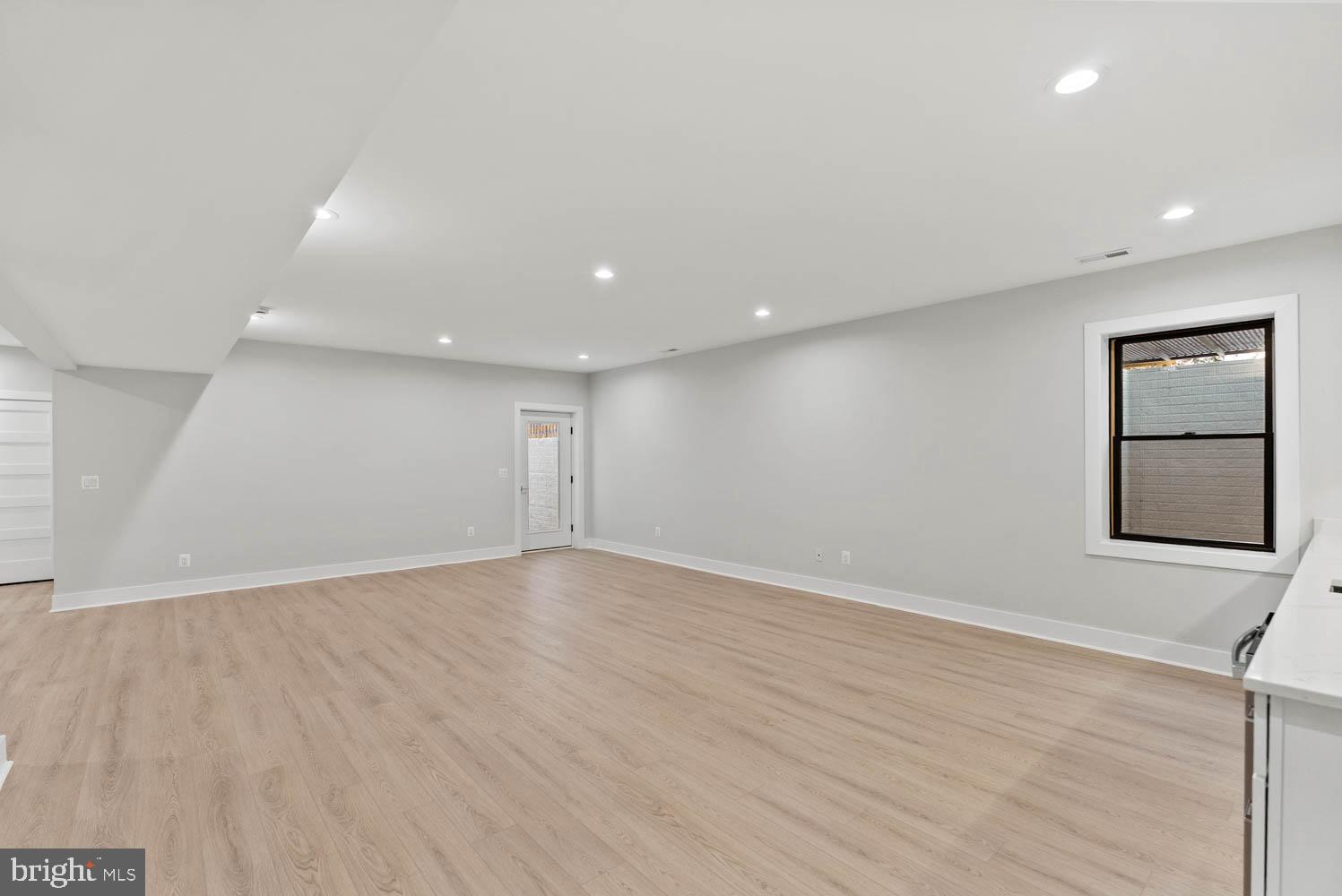 402 Marshall Road Southwest Vienna, VA 22180 - Photo 68 of 78 an empty room with wooden floor and windows