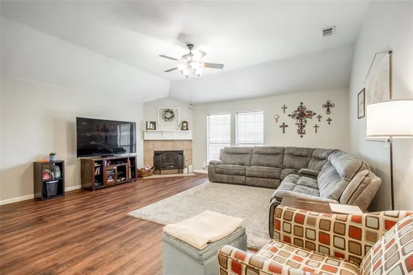 a living room with furniture a flat screen tv and a fireplace