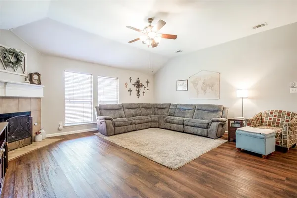 a living room with furniture and a fireplace