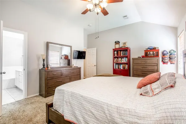 a bedroom with a bed and dresser