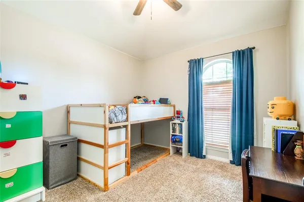 a bedroom with a bed and a desk