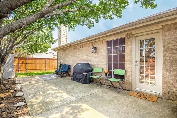 a view of a house with a patio and a yard