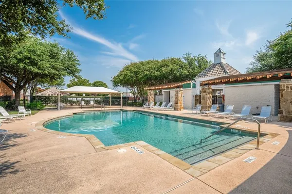 a view of a house with swimming pool and sitting area