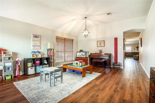 a living room with furniture and wooden floor