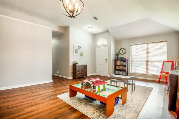 a living room with furniture a rug and a large window