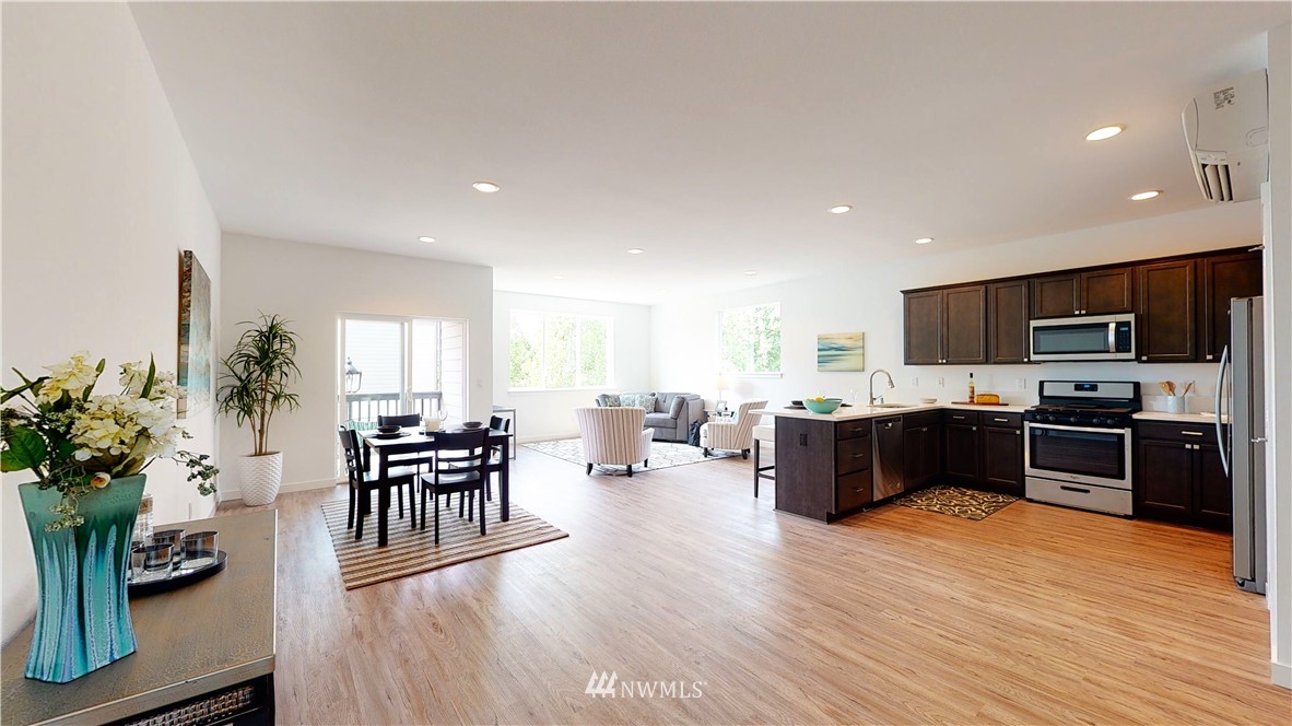 4861 Talbot Road South, Unit B3 Renton, WA 98055 - Photo 2 of 36 a living room with furniture wooden floor and a kitchen view