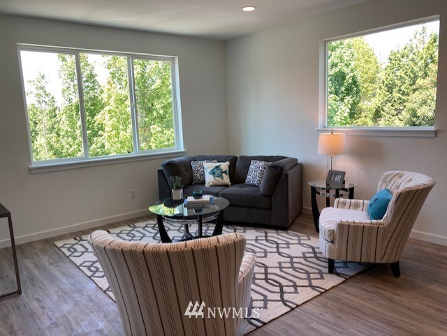 4861 Talbot Road South, Unit B3 Renton, WA 98055 - Photo 13 of 36 a living room with furniture and a large window