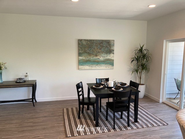 4861 Talbot Road South, Unit B3 Renton, WA 98055 - Photo 14 of 36 a view of a dining room with furniture and wooden floor
