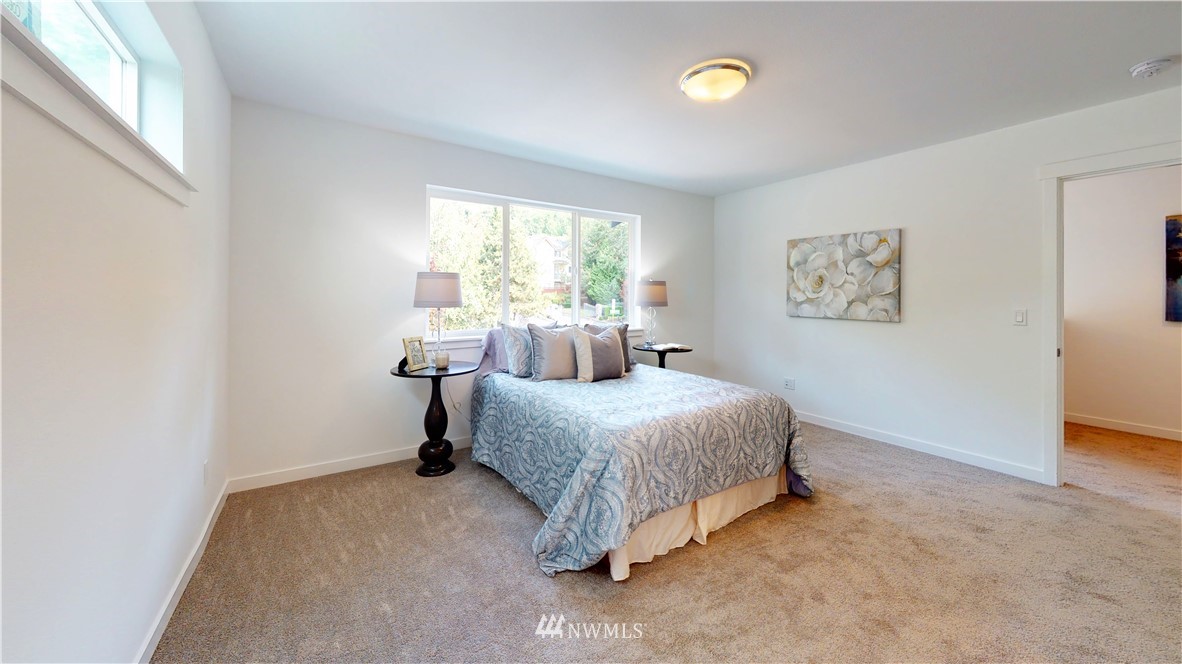 4861 Talbot Road South, Unit B3 Renton, WA 98055 - Photo 30 of 36 a bedroom with a bed and a window