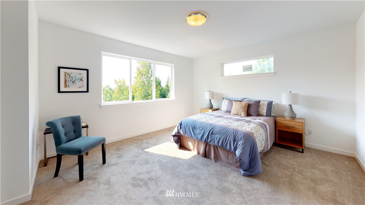 4861 Talbot Road South, Unit B3 Renton, WA 98055 - Photo 32 of 36 a spacious bedroom with a bed and a chair