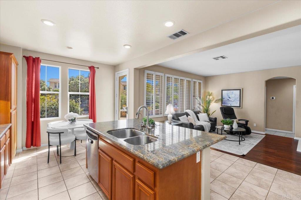 838 Luminara Way San Marcos, CA 92078 - Photo 29 of 54 a kitchen with granite countertop a sink and a stove