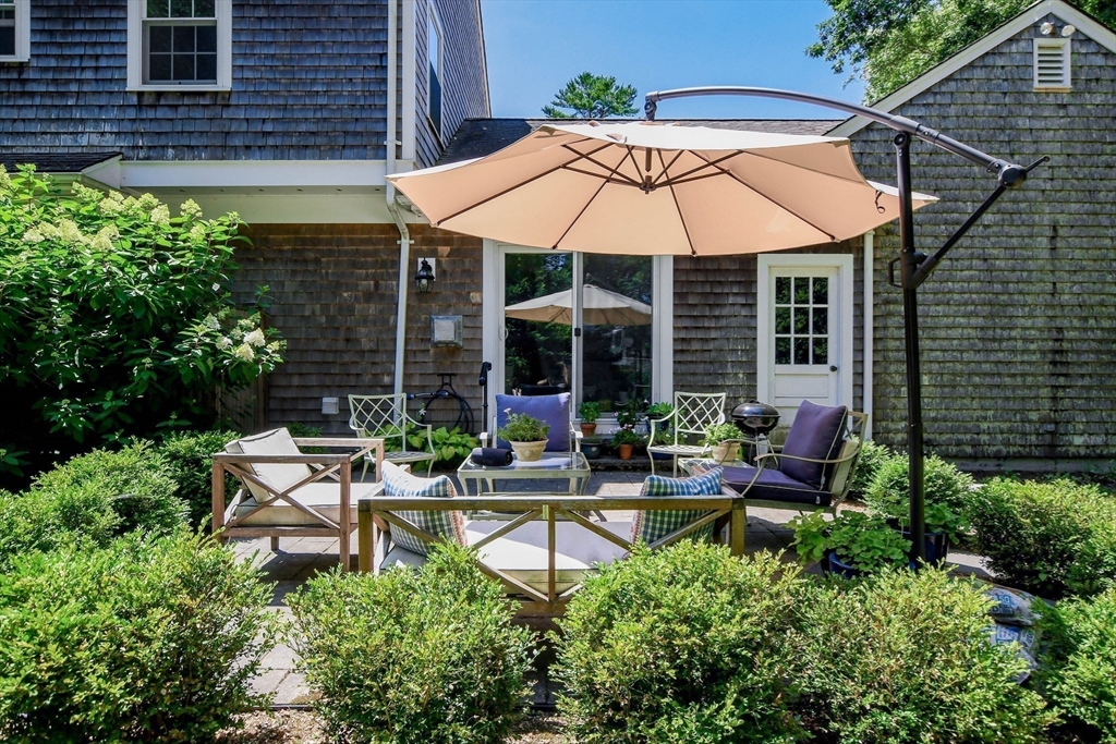17 Olde Knoll Road Marion, MA 02738 - Photo 4 of 38 a view of a chair and table under an umbrella
