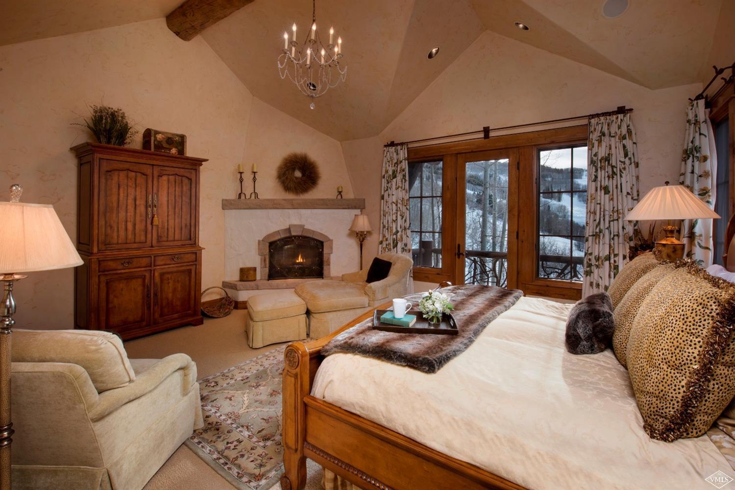 880 Daybreak Ridge Road Beaver Creek, CO 81620 - Photo 12 of 24 a bedroom with a large bed and a fireplace