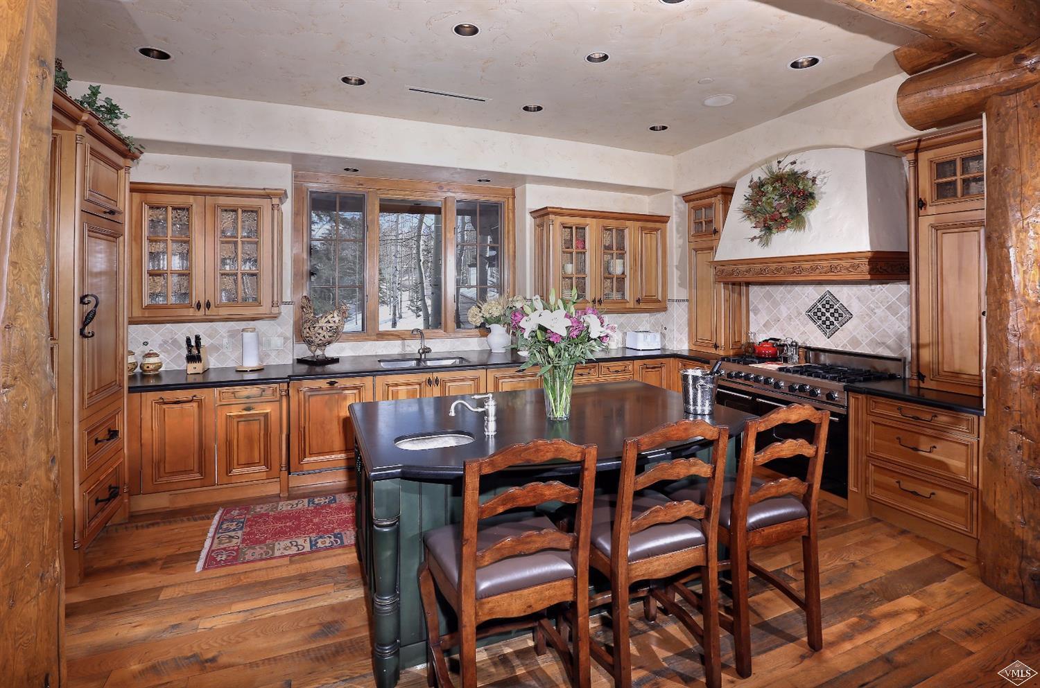 880 Daybreak Ridge Road Beaver Creek, CO 81620 - Photo 14 of 24 a dining hall with stainless steel appliances granite countertop a stove and a dining table