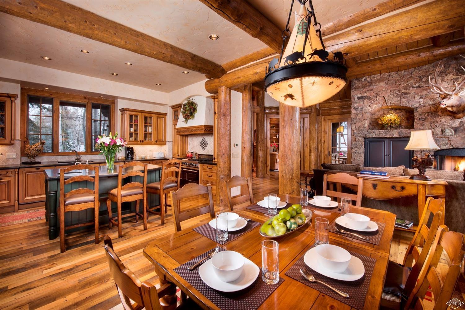 880 Daybreak Ridge Road Beaver Creek, CO 81620 - Photo 9 of 24 a dining room with lots of furniture and chandelier