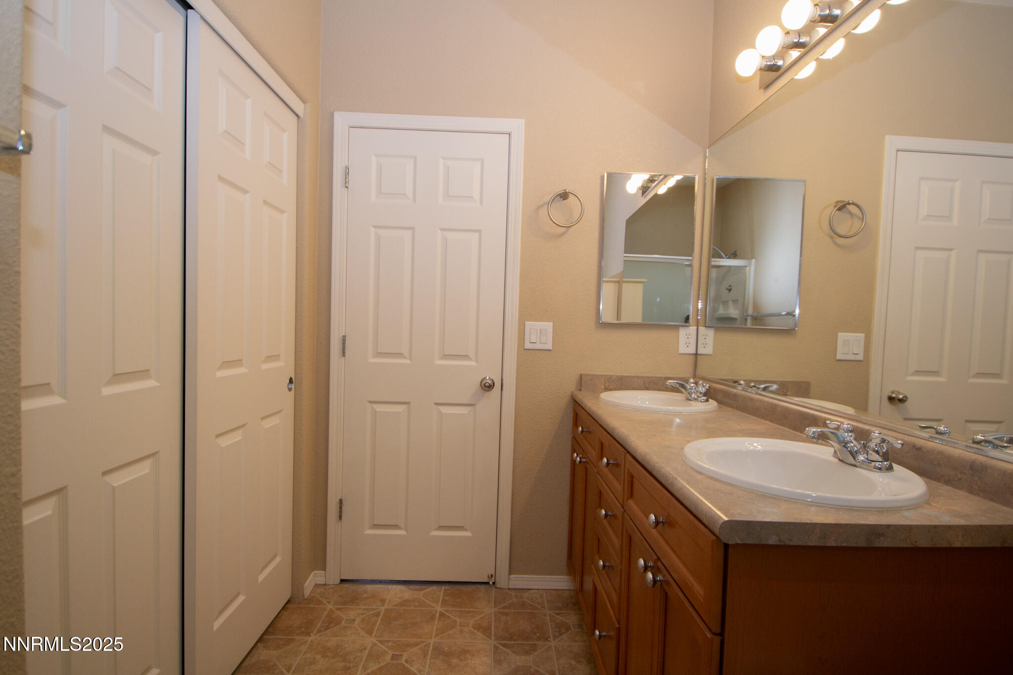 3116 Sterling Ridge Circle Sparks, NV 89431 - Photo 13 of 20 a bathroom with a sink a mirror a vanity and a shower