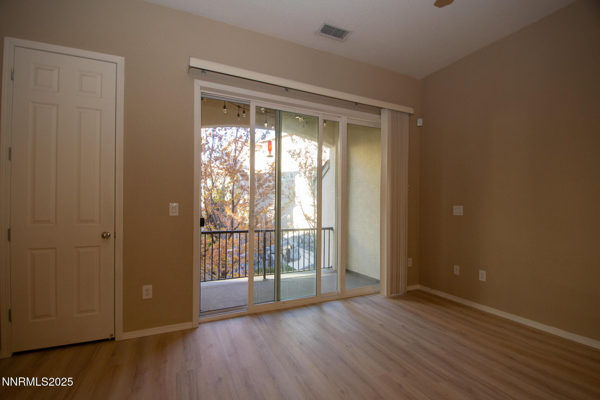 3116 Sterling Ridge Circle Sparks, NV 89431 - Photo 18 of 20 an empty room with wooden floor and windows