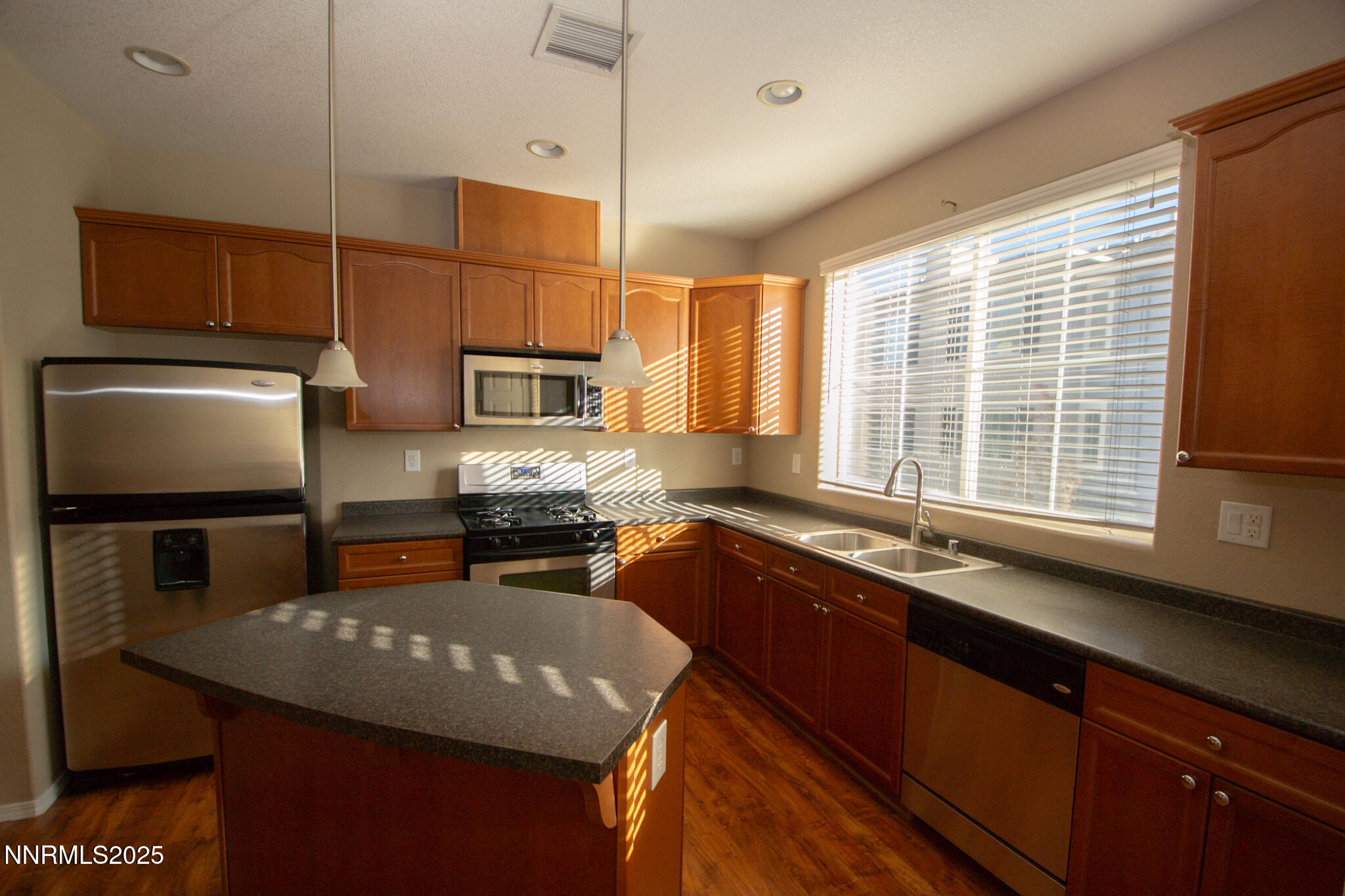 3116 Sterling Ridge Circle Sparks, NV 89431 - Photo 5 of 20 a kitchen with stainless steel appliances granite countertop a sink a stove and a refrigerator