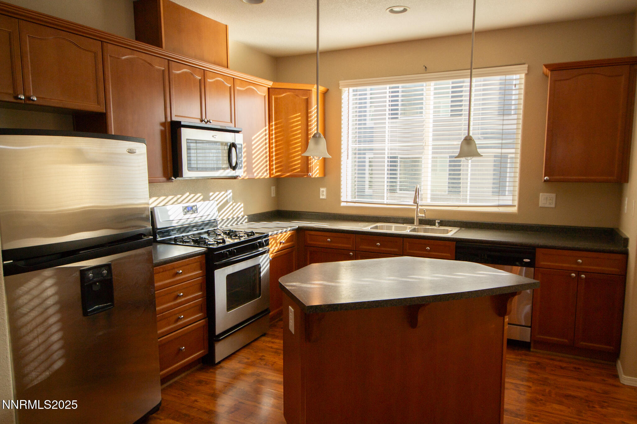 3116 Sterling Ridge Circle Sparks, NV 89431 - Photo 6 of 20 a kitchen with stainless steel appliances granite countertop a stove a sink and a microwave