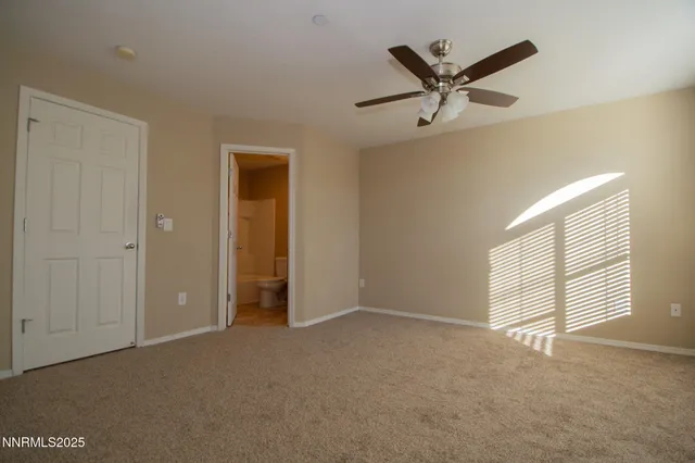 a view of an empty room with a ceiling fan