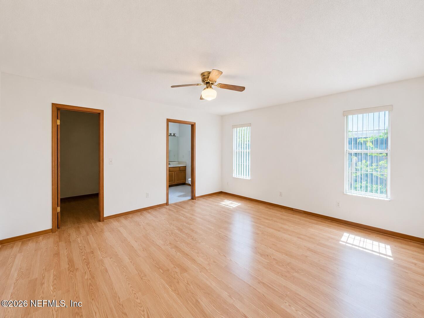 6 Surfcrest Street St. Augustine Beach, FL 32080 - Photo 8 of 15 an empty room with wooden floor ceiling fan and windows