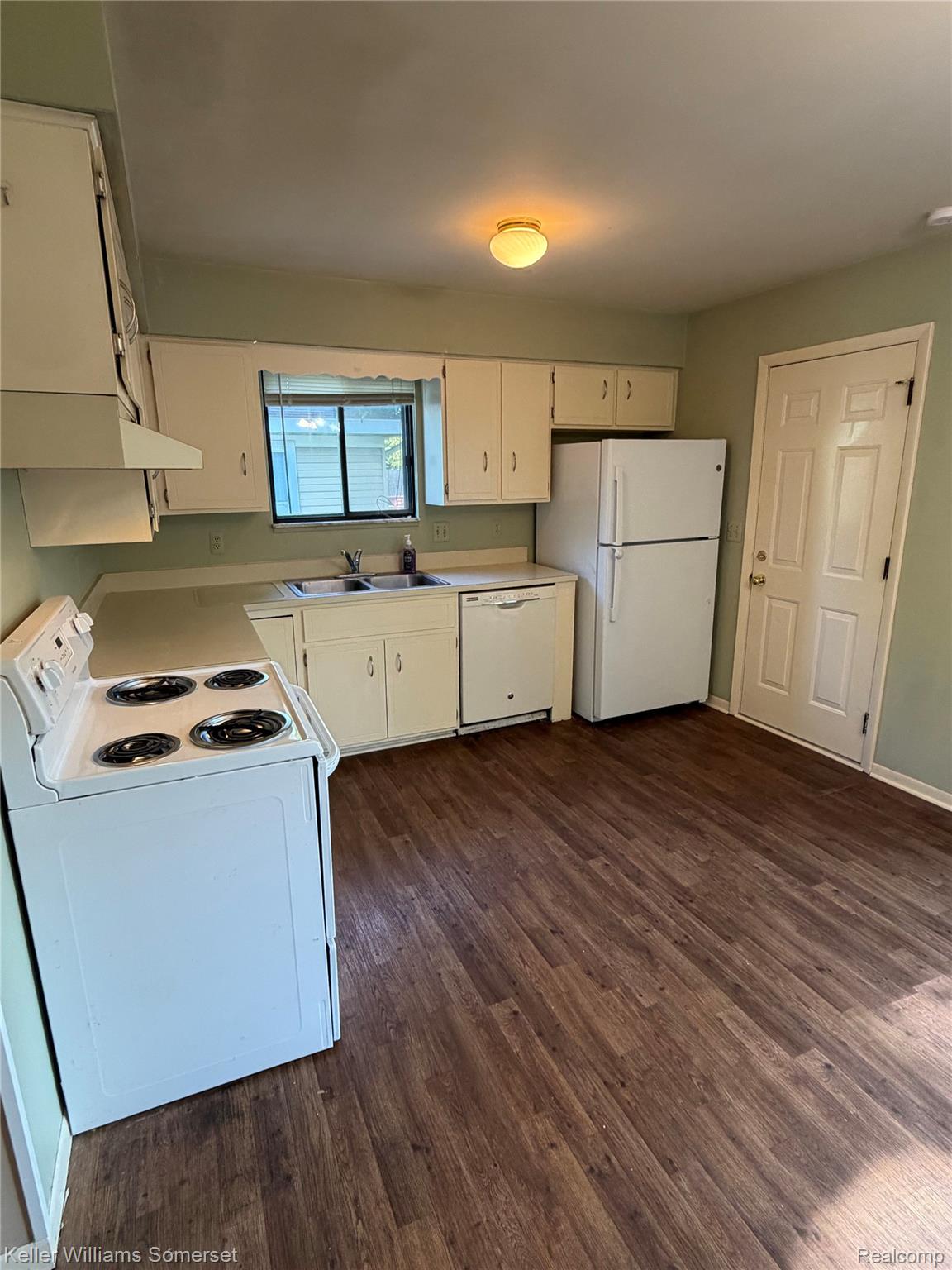 3277 Eastern Avenue Rochester, MI 48307 - Photo 5 of 13 Kitchen featuring wood-finish flooring, white cabinetry, and white appliances
