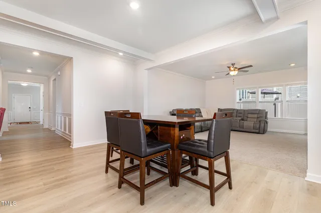 a view of a dining room with furniture and wooden floor