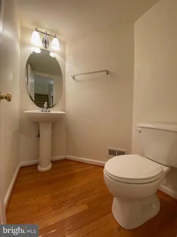 a bathroom with a toilet and a mirror