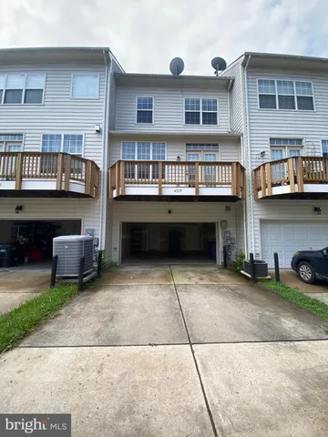 a view of building and car parked in front of house