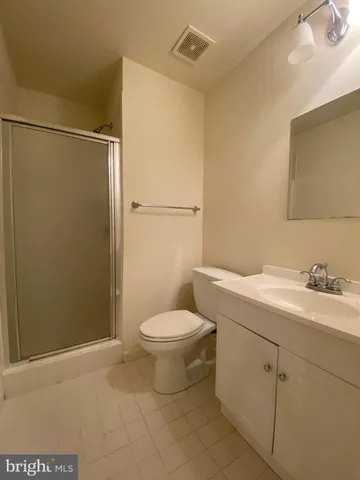 a bathroom with a toilet a sink and a shower