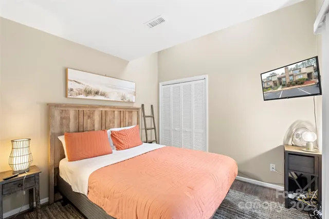 a bedroom with a bed and wooden floor