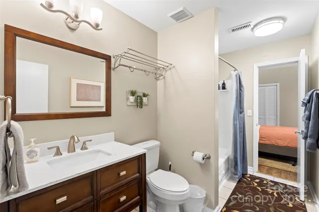 a bathroom with a sink a toilet a shower and a mirror