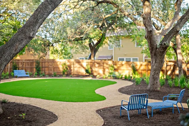 a view of a backyard with garden and patio