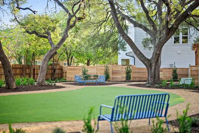 a view of a chair and table in the front of house