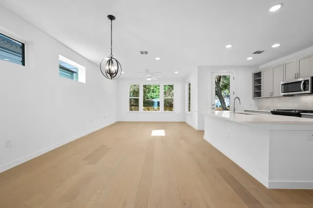 a view of a kitchen with window and stainless steel appliances