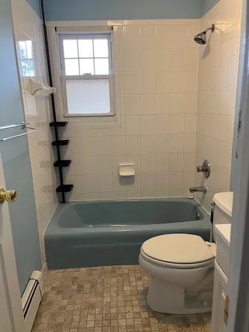 a bathroom with a toilet and a bathtub