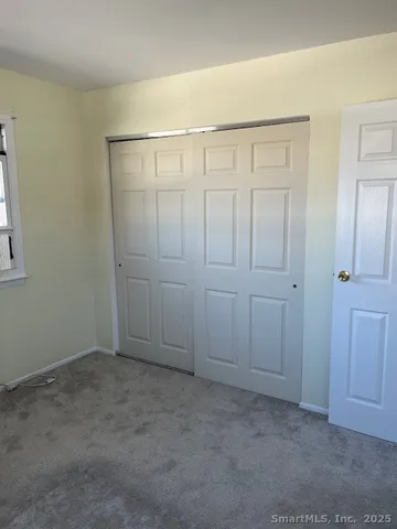 an empty room with closet area
